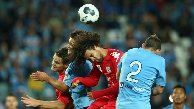 Using his head: Osama Malik during the match between Adelaide United and Sydney FC.