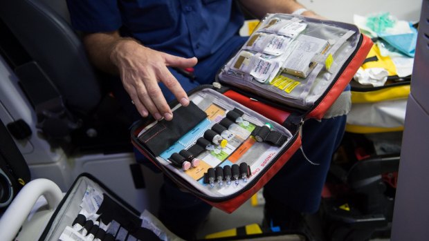 A NSW Ambulance paramedic checks equipment and drug supplies during his shift.