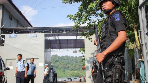 Nusakambangan, the island where the executions will take place, is visible through the gate as police wait for ambulances to arrive.