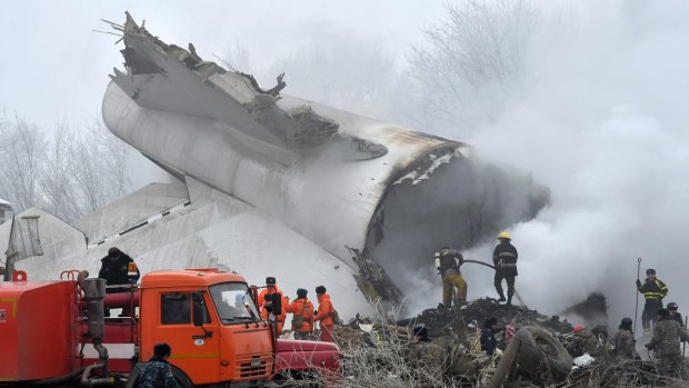 Firefighters work among remains of a crashed Turkish Boeing 747 cargo plane at a residential area outside Bishkek, Kyrgyzstan.