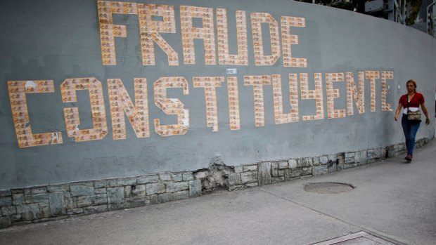 A message on a wall formed with Venezuelan currency that reads: "The Constituent Assembly is a fraud".