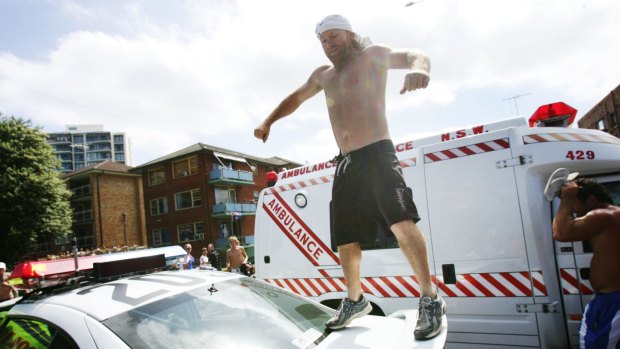 Troy Dennehy, pictured jumping on a police car, suicided two years after the riots.