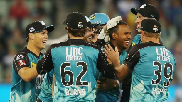 Samuel Badree of the Heat (second from right) is all smiles after taking the wicket of Rob Quiney of the Stars.