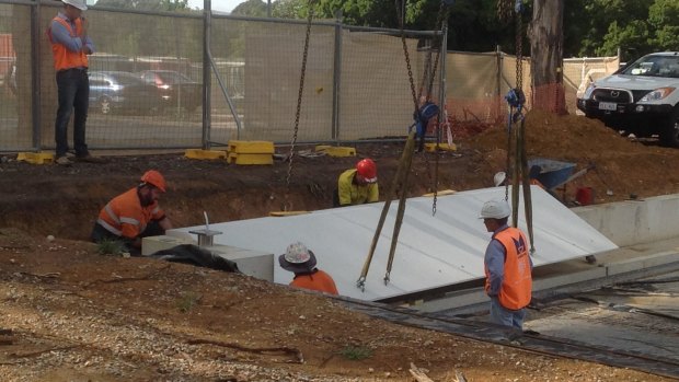 Workers have begun installing the first part of the memorial on Anzac Parade.