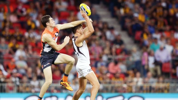 Jeremy Cameron challenges Daniel Howe of the Hawks during the GWS triumph over Hawthorn.