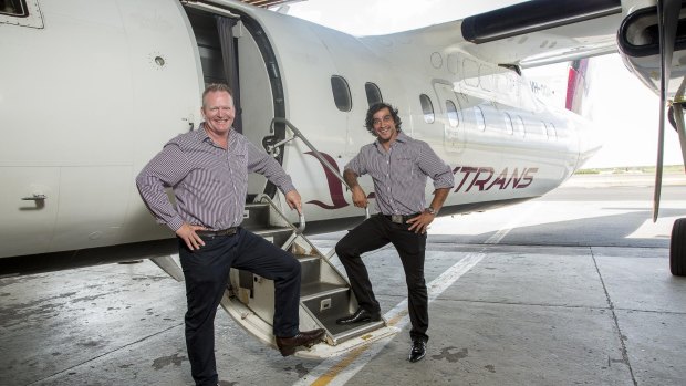 Skytrans co-owner Peter Collings with footballer and shareholder Johnathan Thurston in front of a Dash-8.