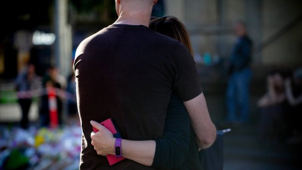 People mourn and pay their respects to those who were killed by the driver who ran his car through pedestrians  on Friday.