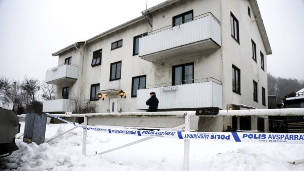 A police officer stands guard at the entrance of a migrant centre in Molndal outside Gothenburg, Sweden, on Monday. Employee Alexandra Mezher, 22, was killed in a knife attack inside the centre.