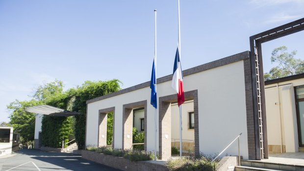 In shock: Flags at the French embassy at Yarralumla fly at half mast on Thursday morning.