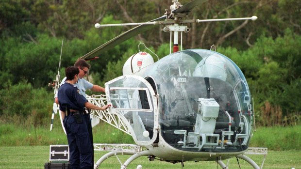 Police inspect the helicopter used to to remove John Killick from Silverwater jail.