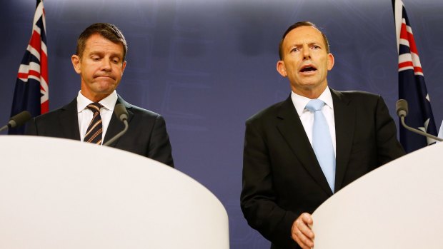 The re-election chances of the government of NSW Premier Mike Baird, left, are being eroded by the unpopularity of Prime Minister Tony Abbott.