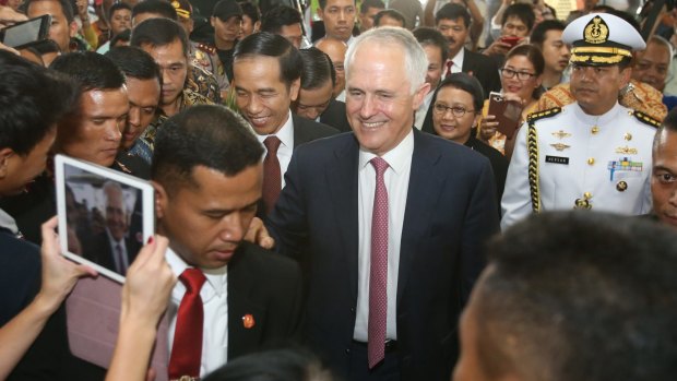Joko Widodo and Malcolm Turnbull during a stroll through a local textile market.