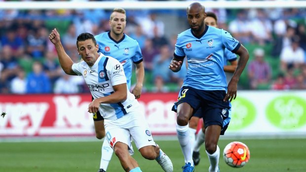 Robert Koren of Melbourne City gets rid of the ball as Mickael Tavares of Sydney FC approaches.