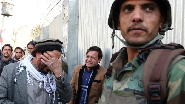 Men cry after an attack on a military hospital in Kabul, Afghanistan.