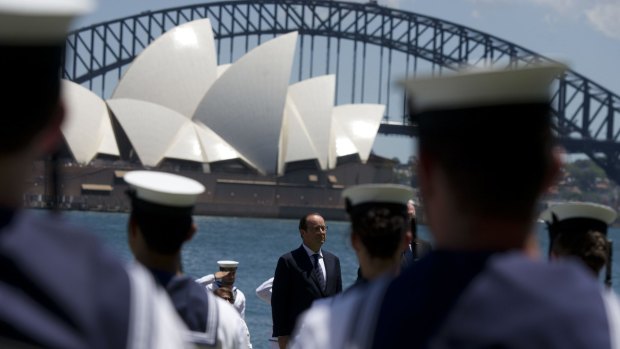 French President Francois Hollande attends a 21-gun salute on the harbour.