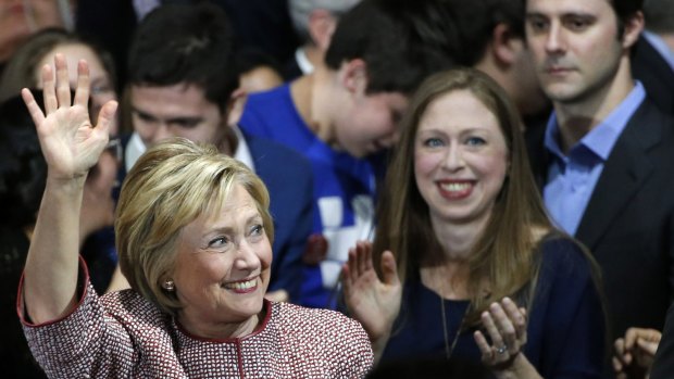 Democratic presidential candidate Hillary Clinton waves to supporters as she enters the room with daughter Chelsea Clinton and son-in-law Mark Mezvinsky.