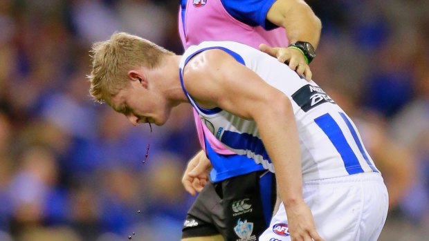 Collision: Jack Ziebell leaves the field injured, with blood coming from his mouth during the match against Port Adelaide.