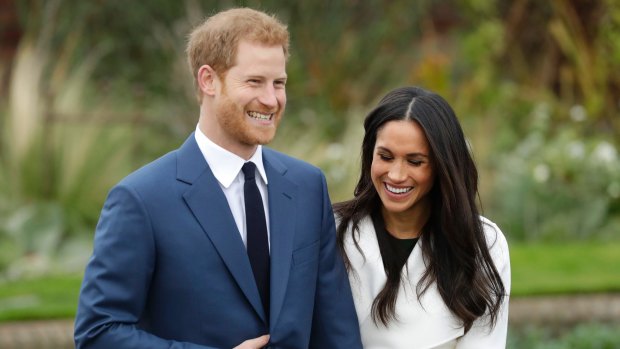 Britain's Prince Harry and his fiancee Meghan Markle pose for photographers during a photocall in the grounds of Kensington Palace in London, Monday Nov. 27, 2017. Britain's royal palace says Prince Harry and actress Meghan Markle are engaged and will marry in the spring of 2018. (AP Photo/Matt Dunham)