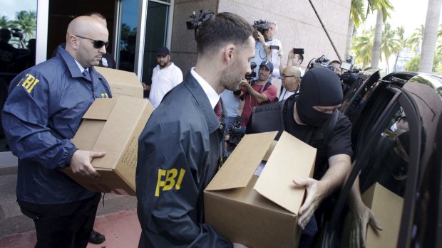 FBI agents load boxes at the Confederation of North, Central American and Caribbean Association Football offices in Miami.