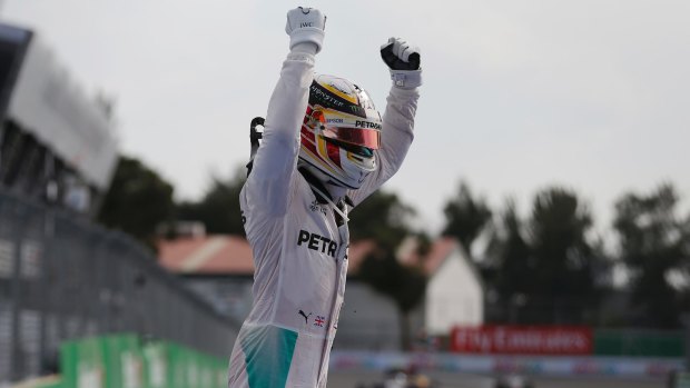 Mercedes driver Lewis Hamilton celebrates after winning the Mexico Grand Prix.