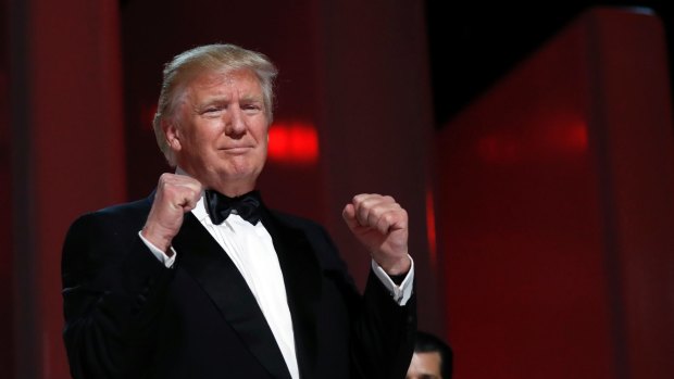 President Donald Trump acknowledges the crowd at the Liberty Ball, Friday, Jan. 20, 2017, in Washington. (AP Photo/Alex Brandon)