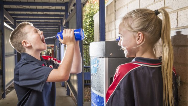 Year 6 students Declan Yates and Kim Shoard, both 11, use the new water resource station at Monash Primary School. 
