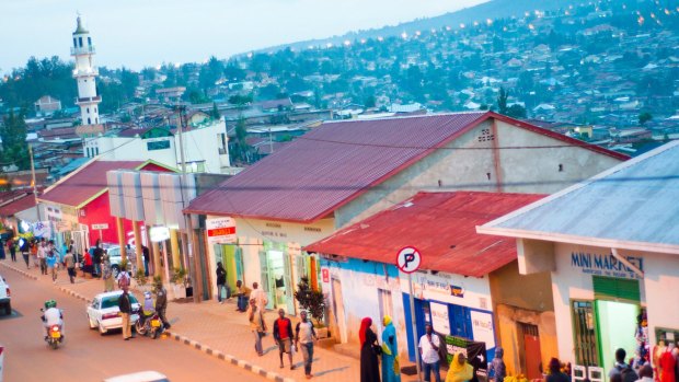 The main street - KN 2 Avenue - at dusk, with hillside suburbs beyond, Nyamirambo, Kigali, Rwanda.