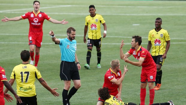 Referee Chris Beath gives Albert Riera a second yellow card, reducing the Wellington Phoenix to 10 men.