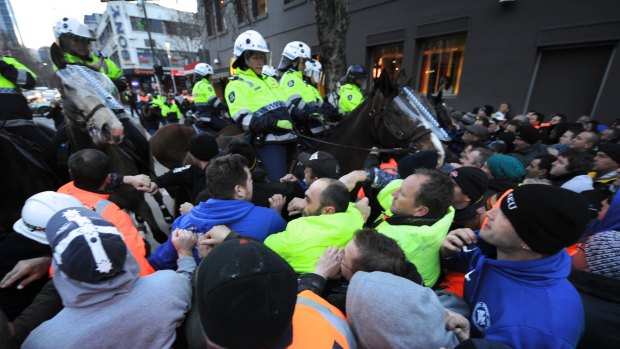 Striking CFMEU members clash with police in Melbourne in 2012.
