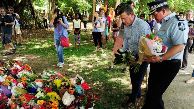 Acting Premier Tim Nicholls lays down flowers at the makeshift memorial to eight children who died in a Cairns home.
