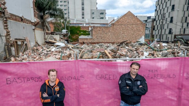 Trades Hall secretary Luke Hilakari, left, and CFMEU boss John Sekta in front of pub's remains. Unions last week banned construction on the site. 