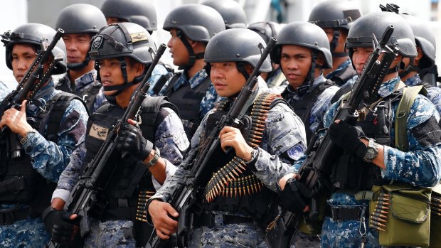 An armed Philippine coast guard unit leave the liberated Marawi late last year.