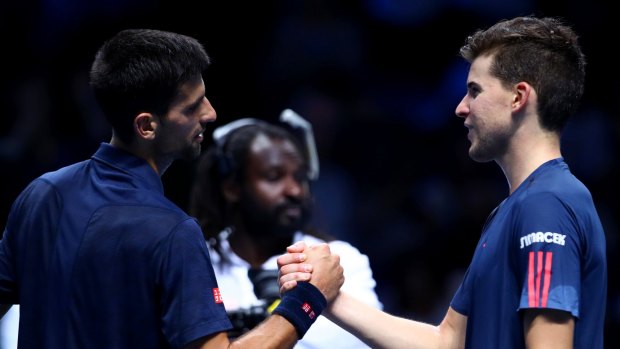 Novak Djokovic shakes hands with Dominic Thiem.