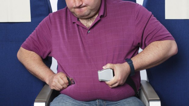 Flying tips.
Frustrated overweight man in an airplane trying to close his short seat belt
str12cover