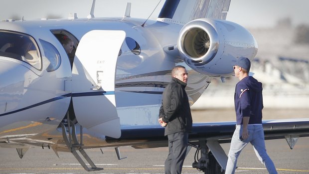 Pixie waits in the doorway as her father Oliver Curtis boards a jet for his return to Sydney.