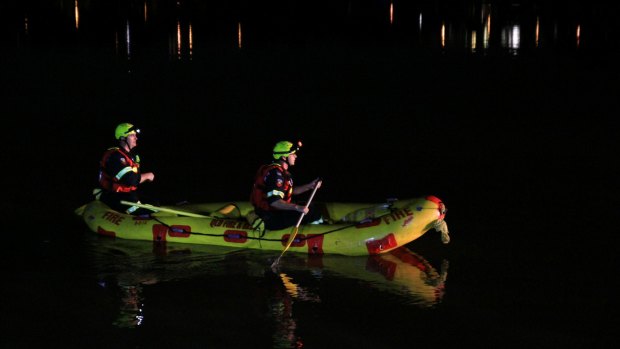 Rescue teams scour the Brisbane River for a missing man on Saturday.