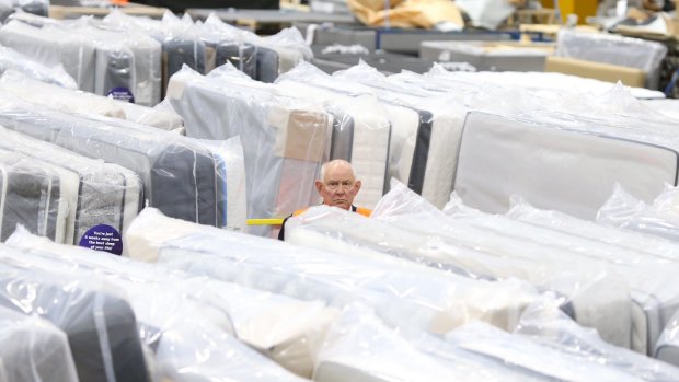Prime Minister Malcolm Turnbull's advancer Vincent Woolcock at a mattress factory. 
