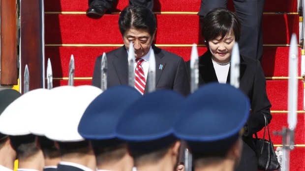 Japanese Prime Minister Shinzo Abe and his wife Akie are greeted by a Chinese honour guard at Beijing Capital Airport on Sunday.