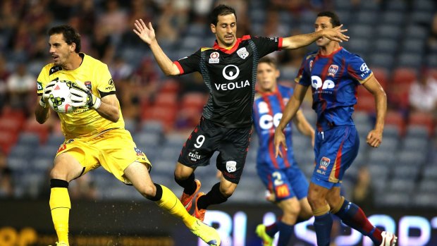 Newcastle custodian Ben Kennedy saves an attempt at goal by Adelaide United's Sergio Cirio.