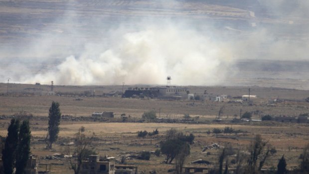 A picture taken from Golan Heights shows smoke rising following explosions in a village in Syria's Quneitra province.