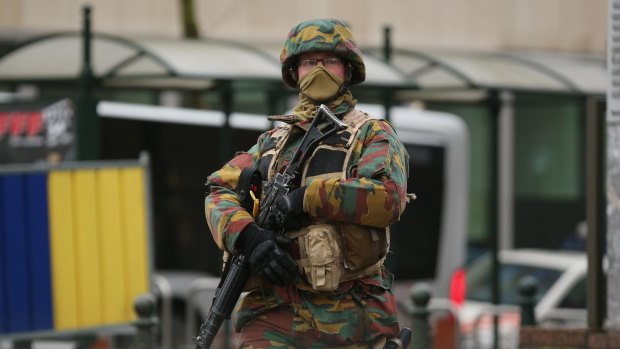 An armed soldier patrols near the EU Commission headquarters after this week's terrorist attacks.