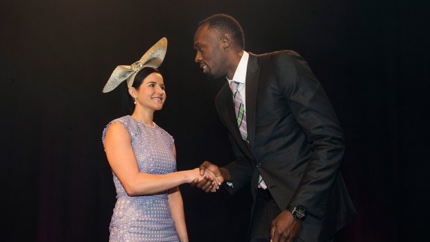 Usain Bolt and Michelle Payne meet at the Oaks Club Luncheon.
