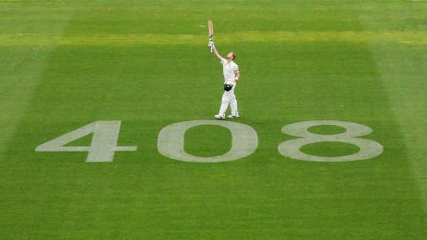 Steve Smith salutes Phillip Hughes after making his century.