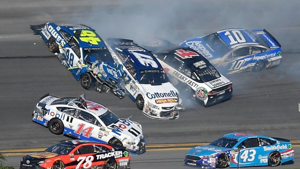Jimmie Johnson (48), Clint Bowyer (14), Chris Buescher (37), Kevin Harvick (4) and Danica Patrick (10) collide between turns three and four.