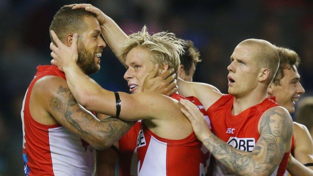 Lance Franklin of the Swans with Isacc Heeney and Zak Jones.