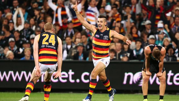 Overpowered: Taylor Walker helped Adelaide square the Showdown ledger against rivals Port.