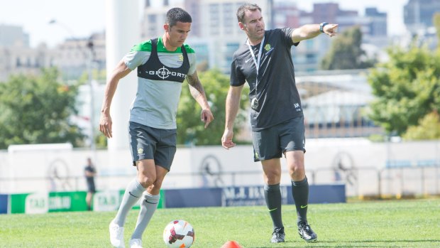 Tim Cahill with coach Ange Postecoglou during a training session in Melbourne on Sunday.
