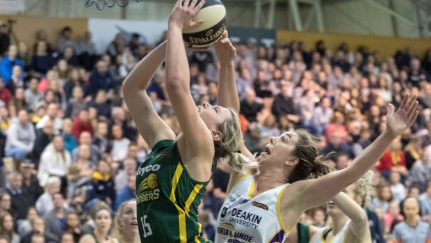 Dandenong star Sara Blicavs goes to the basket against Melbourne Boomers' Jenna O'Hea in round one.