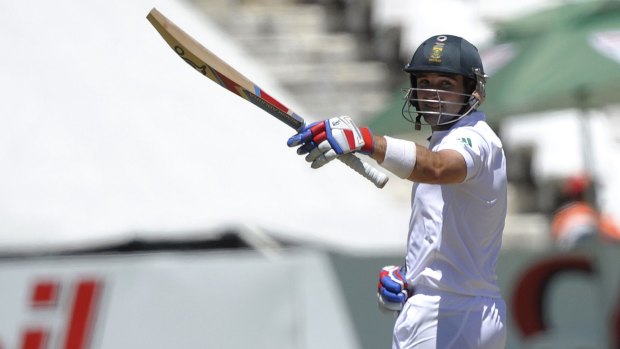 Dean Elgar raises his bat to acknowledge the applause after reaching his half-century.