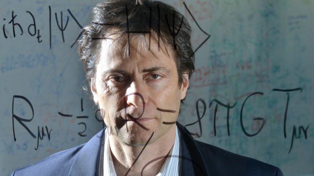 Max Tegmark, a Physics professor at MIT, stands behind the Schršdinger equation for quantum mechanics (top) and Einstein's general theory of relativity (bottom).